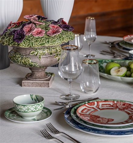 Vista Alegre | The Meaning Charger Plate displayed in an elegant table setting with floral centerpiece, gold-rimmed glassware, and coordinated dinnerware.