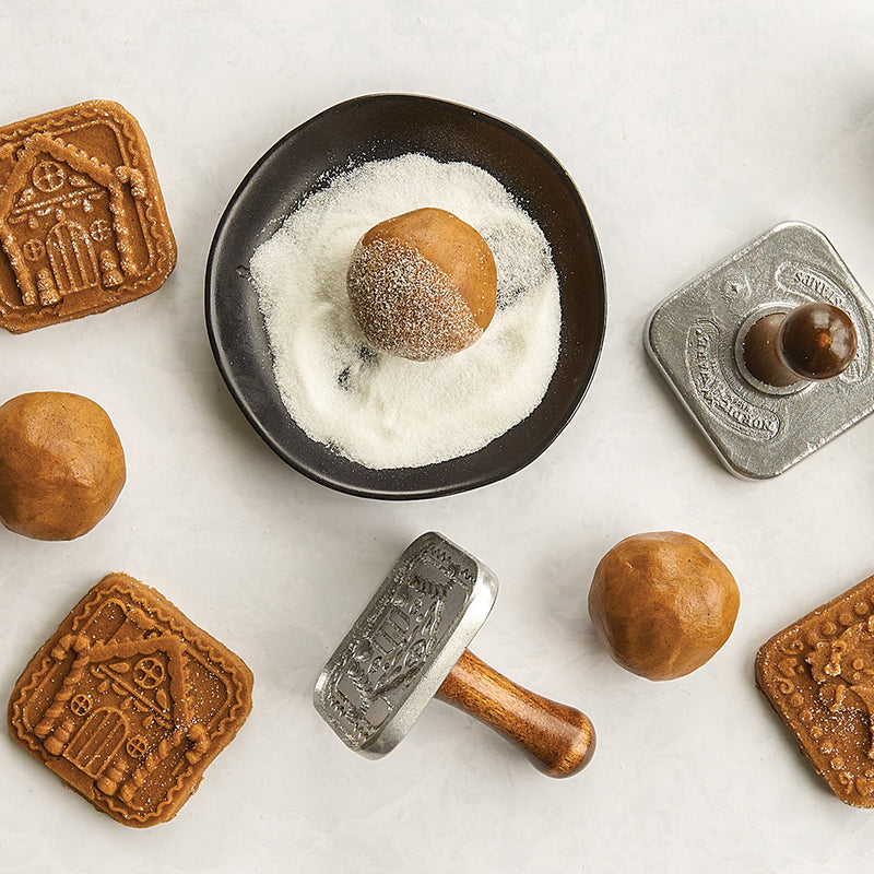 Nordic Ware | Gingerbread cookie stamps with intricate holiday designs, perfect for crafting festive treats. Includes gingerbread boy, girl, and house shapes.