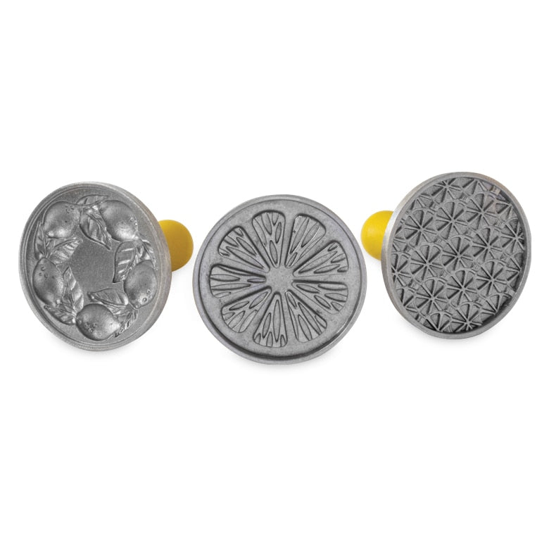 Nordic Ware | Citrus Cookie Stamps, featuring round metal stamps with citrus fruit patterns for imprinting designs on cookies. Ideal for enhancing Key Lime or lemon shortbread cookies.