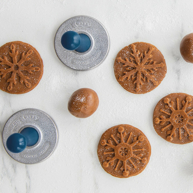 Nordic Ware | Snowflake Cookie Stamps - Set of 3 featuring intricately embossed designs, cast aluminum with wooden handles, perfect for creating festive cookies at holiday gatherings.