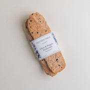 Potters Table - Cured Olive & Cracked Pepper Flatbreads, two hand-stretched, cracker-style flatbreads flecked with black pepper, wrapped in bakery label.