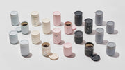 W&P Reusable Ceramic Mug: Terrazzo Charcoal, 16 oz with a BPA-free splash-resistant lid, shown among other containers, emphasizing sustainable, stylish coffee enjoyment.