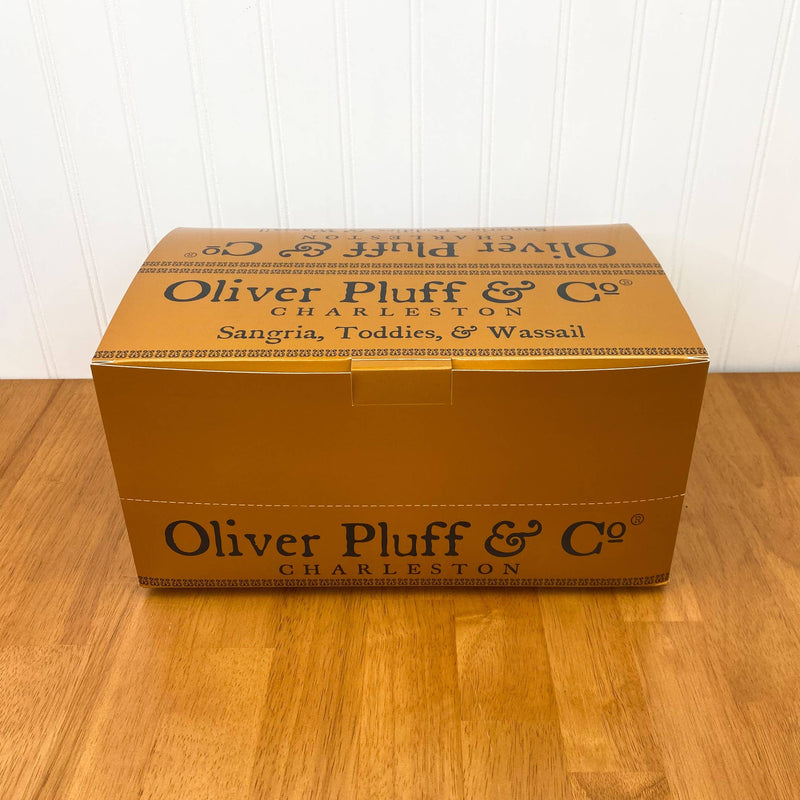 Oliver Pluff & Company - Orange Clove Hot Toddy Kit packaged in a mustard-yellow box, featuring spices for crafting a gallon of warming winter drink.