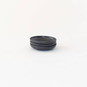 Sarah Kersten - Olive Dish: Basin Collection: Fig, featuring a stack of sleek, black plates, ideal for versatile kitchen use in Athens Cooks' curated collection.