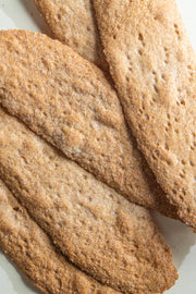 Potters Table - Salted Olive Oil Flatbreads: thin, whole-grain crackers with coarse salt, ideal for pairing with cheese or spreads, embody rustic, handcrafted quality from Hudson Valley.