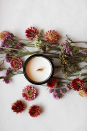 Among the Flowers | Essential Oil + Soy Wax Candle Domes in a dark vessel, surrounded by dried flowers, showcasing a natural, low-smoke candle option.