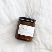 Among the Flowers | Essential Oil + Soy Wax Candle Wilder in an amber-brown glass jar with a handcrafted label, perfect for a natural touch to your kitchen ambiance.