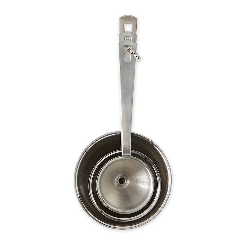 RSVP Mini Funnel Set of 3, stainless steel funnels for precise pouring in kitchens, shown with a ladle and measuring cups.