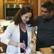 Couple in kitchen using Burlap & Barrel - Garam Masala - Single Origin Spice & Seasoning Blend, highlighting its versatility in home-cooked Indian dishes.