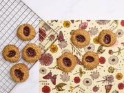 Bee's Wrap - Bread Wrap - Meadow Magic, Plant Based Wax, showcasing nut-based cookies with jam on beeswax wrap, highlighting sustainable kitchen solutions from Athens Cooks.