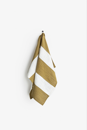 Striped linen tea towel on a hook, featuring a loop for hanging, part of MagicLinen's zero-waste collection, designed for practical kitchen use.