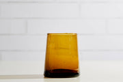 Set of six Moroccan Cone Glassware Small - Amber, hand-blown from recycled bottles, featuring organic forms and bubbles for versatile beverage use or table decor.