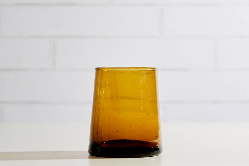 Set of six Moroccan Cone Glassware Small - Amber, hand-blown from recycled bottles, featuring organic forms and bubbles for versatile beverage use or table decor.