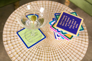 Drinks on Me - COASTER Dinner Time: Mosaic-top table with humorous coasters, martini glass adds charm; perfect for playful home bar decor or gifts.