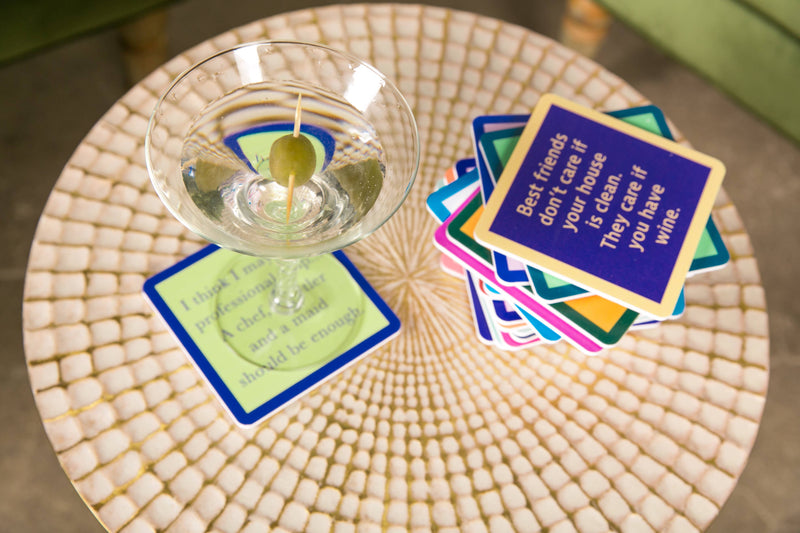 Drinks on Me - COASTER Dinner Time: Mosaic-top table with humorous coasters, martini glass adds charm; perfect for playful home bar decor or gifts.