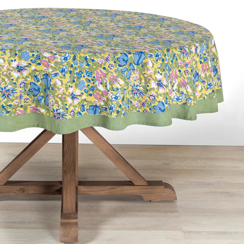 Caravan Home 71 x 71 Jardin Blue & Vert Tablecloth, featuring a floral pattern on a round table, handprinted for a lush garden-inspired look.