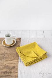 MagicLinen - Set of 2 linen napkins on a table with a white coffee cup, highlighting the elegance and versatility of these premium-quality, sustainable table decor items.