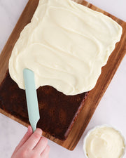 GIR | Ultimate Spreader - Sprinkles being used to smoothly spread frosting on a cake, showcasing its ergonomic design and versatility for various culinary tasks.