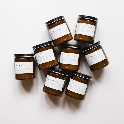 Among the Flowers - Essential Oil + Soy Wax Candle: Sitka, in a brown glass jar with a white label, featuring wood wick and aromatic scents.