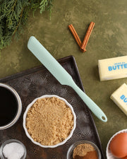 GIR | Ultimate Spreader - Sprinkles alongside kitchen ingredients like butter, cinnamon sticks, and brown sugar on a tray, highlighting its versatile culinary uses.