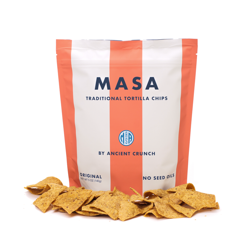Ancient Crunch | Masa Chips, Traditional Tortilla: 5 oz pouch of seed oil-free chips with scattered yellow corn chips, highlighting organic corn, grass-fed tallow, and sea salt.