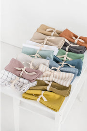 Set of two linen napkins, folded and tied with ribbon, showcasing MagicLinen's versatility for table decor. Perfect for sustainable, stylish dining.