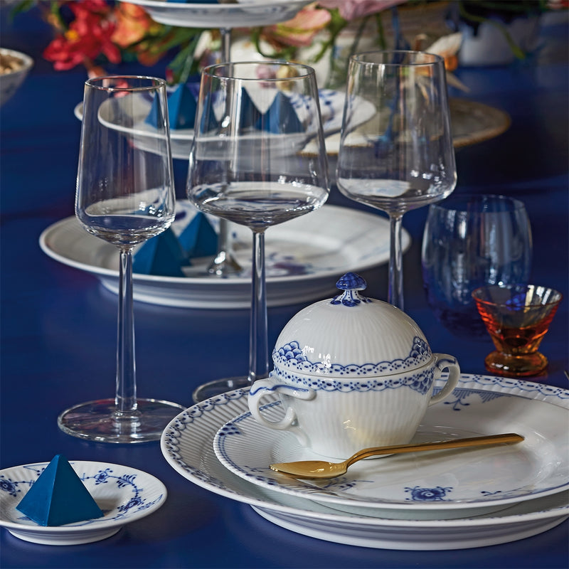 Royal Copenhagen Princess Plate, 27cm, with hand-painted lace and fish scale design, elegantly set with matching porcelain and gold-handled spoon on a formal table setting.