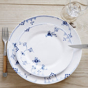 Royal Copenhagen | Blue Elements Plate, 28cm, with a blue floral pattern, set on a table with a knife, fork, and glass, ideal for elegant dining.