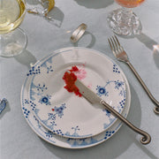 Royal Copenhagen | Blue Elements Plate, 19cm with blue floral pattern, holds fish roe. Set alongside elegant stemware and cutlery, embodying Athens Cooks' curated kitchen elegance.