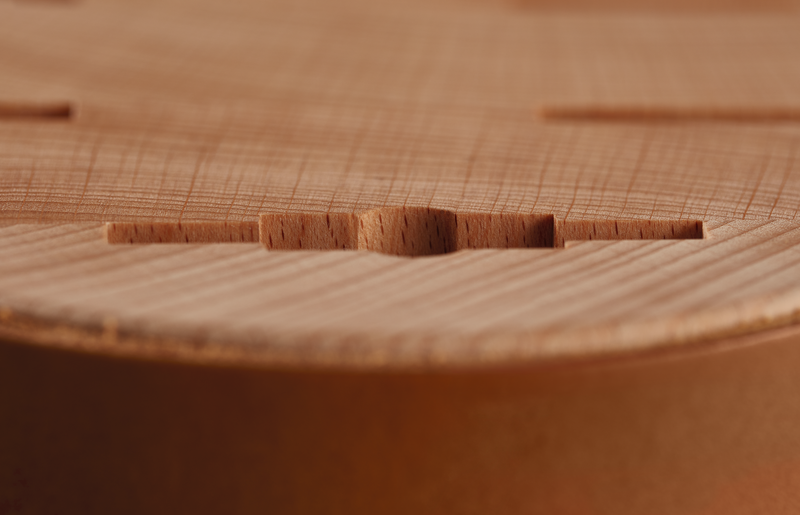 Close-up of Wüsthof 6-Slot Block in beech wood with leather detailing, showcasing its fine craftsmanship and wood surface texture.