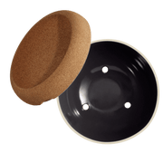 Emile Henry | Deep Storage Bowl, Truffle: A cork lid and black ceramic bowl with drainage holes for storing and preserving fruits and root vegetables effectively.