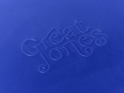 Great Jones | Little Sheet - Pepper: A close-up of elegant blue calligraphy on a quarter-sized, nonstick sheet pan, ideal for small baking tasks.