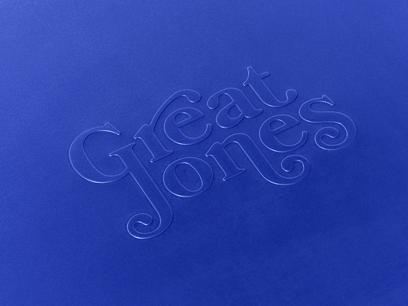 Great Jones | Little Sheet - Pepper: A close-up of elegant blue calligraphy on a quarter-sized, nonstick sheet pan, ideal for small baking tasks.