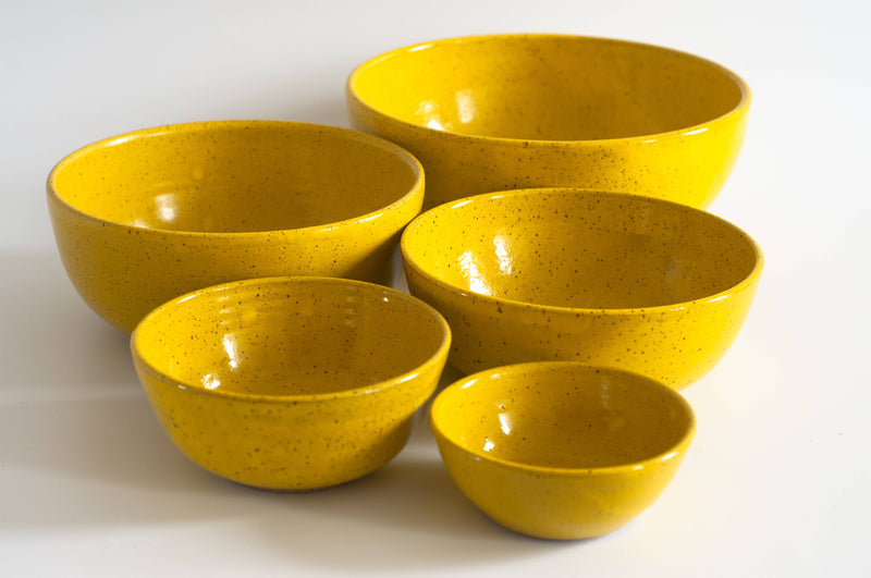 RachaelPots - Nesting Bowls Set Of Five: Light Blue, featuring yellow ceramic bowls with speckled design, hand-trimmed foot, ideal for versatile kitchen use.