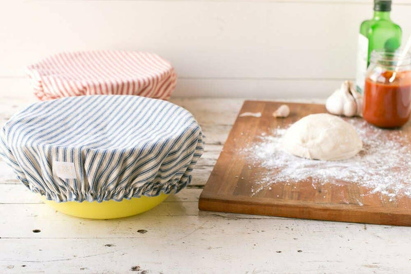 Reusable Bowl Covers - Denim Blue Ticking: Close-up of a fabric cover snugly fitting a bowl, showcasing a sustainable, stylish food protection solution from Athens Cooks.
