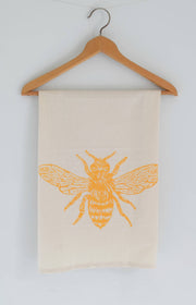 Hearth and Harrow Honeybee Tea Towel in organic cotton, featuring a yellow bee design. Screen printed, eco-friendly, with a hanging loop. Perfect for kitchen use.