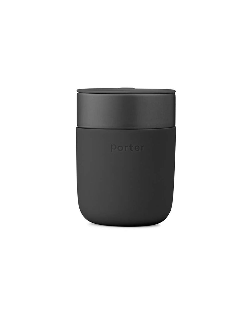 Reusable W&P Ceramic Mug with splash-resistant lid, ideal for reducing waste. Features a matte silicone sleeve for grip, perfect for home-brewed beverages.