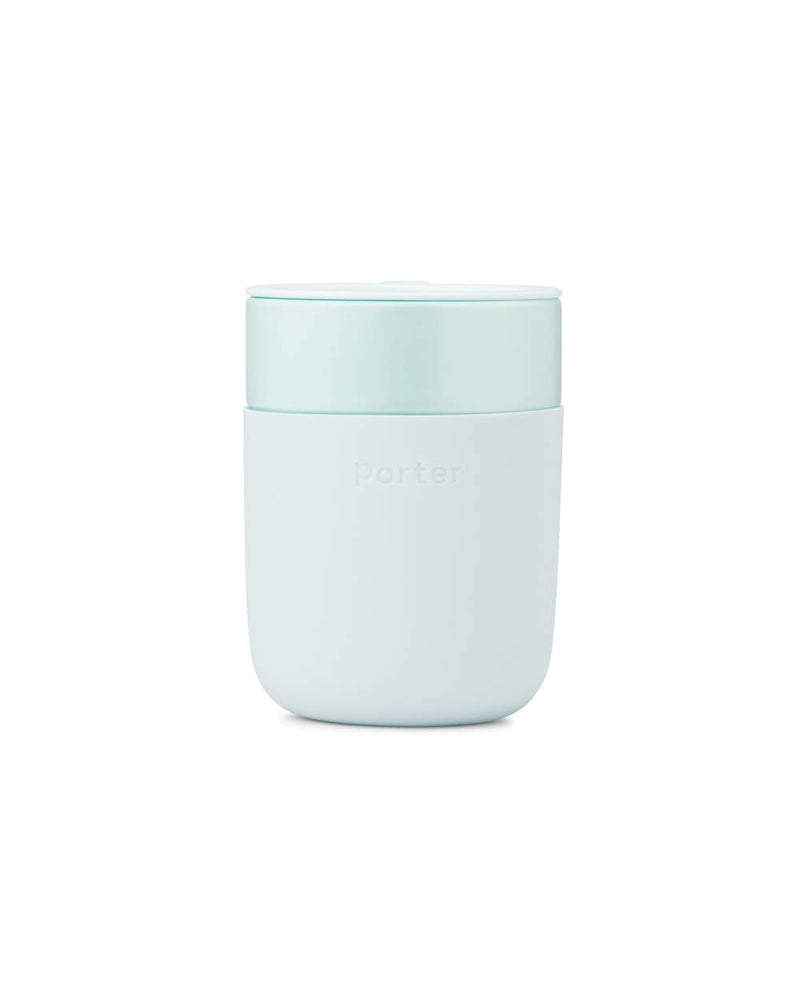 Reusable ceramic mug with a splash-resistant lid and a silicone sleeve for grip, ideal for reducing waste. W&P - Reusable Ceramic Mug: Terrazzo Charcoal, 16 oz.