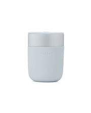 W&P - Reusable Ceramic Mug: Terrazzo Blush / 16 oz, shown with a lid and soft-touch silicone sleeve for easy grip, ideal for eco-friendly beverage enjoyment.