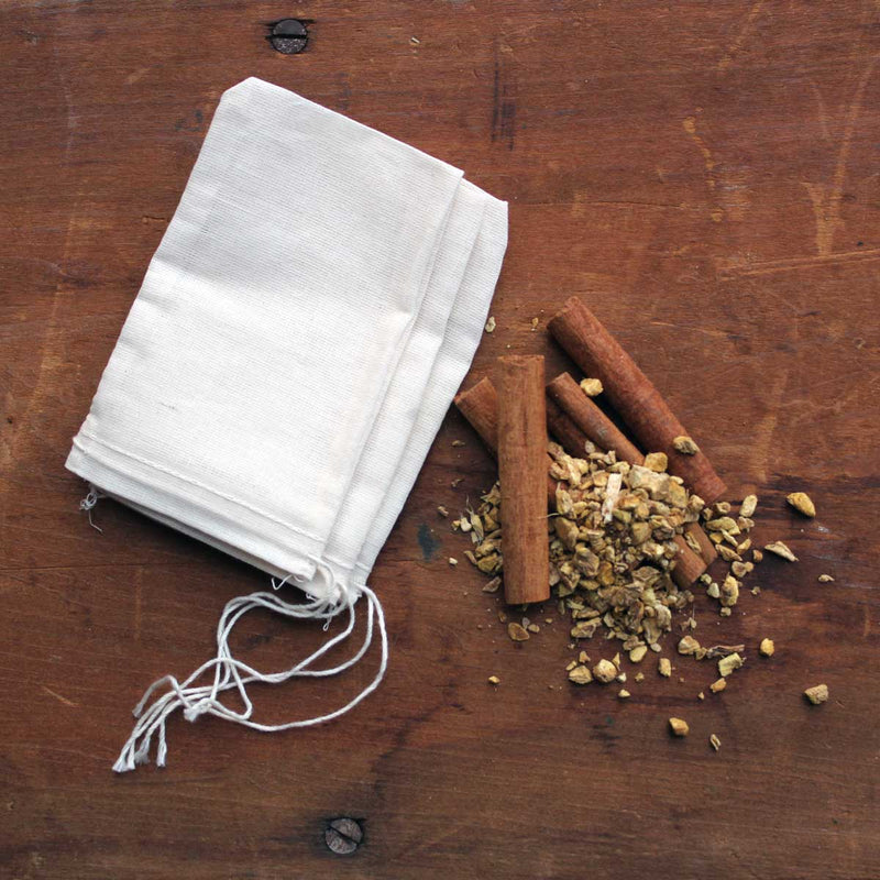Oliver Pluff & Company - Orange Clove Hot Toddy Kit with muslin bag, cinnamon sticks, and dried roots, ideal for creating warm, spiced beverages.