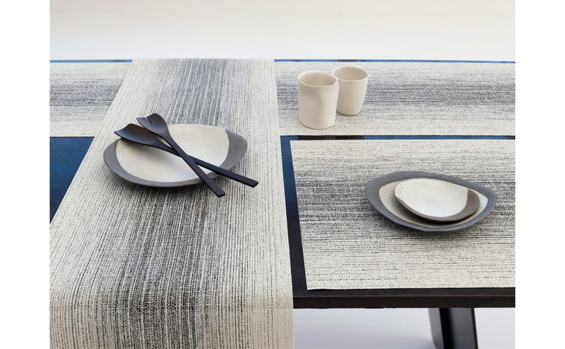 Chilewich | Ombre Rectangle Placemats - Natural displayed on a table set with plates and utensils, highlighting the textured weave and subtle ombré effect.