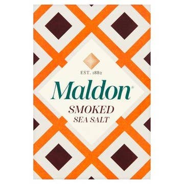 Wholesome Good - Maldon Smoked Sea Salt 4.4 oz package with distinctive diamond-patterned design, highlighting its cold-smoked oak flavor and delicate pyramid flakes for cooking versatility.