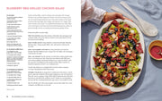 Wishbone Kitchen Cookbook open to Blueberry BBQ Grilled Chicken Salad recipe with ingredients and instructions on one side, styled dish on the other.