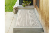 Chilewich | Skinny Striped Shag Mat - Ocean, tufted and durable floor mat on concrete step, ideal for indoor or outdoor use with non-skid backing.