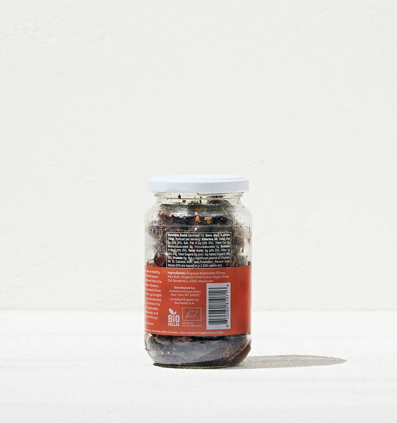 Kosterina - Spicy Kalamata Olives jar with a red label, showcasing organic olives flavored with chili peppers and rosemary, ideal for salads or snacking.