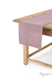 MagicLinen - Linen table runner on a wooden table, showcasing its versatility for kitchen decor with soft, easy-care material, available in various sizes and colors.