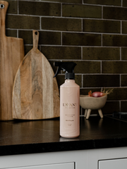L'AVANT Collective - Multipurpose Surface Cleaner - Blushed Bergamot on a counter, ideal for kitchen surfaces, in a refillable luxury bottle.