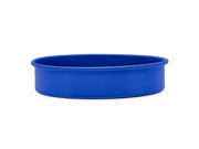 Great Jones | Patty Cake - Broccoli, a ceramic baking bowl with a wavy, corrugated bottom for easy release, displayed against a dark backdrop.