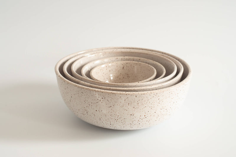 RachaelPots - Nesting Bowls Set Of Five: Light Blue, featuring stacked speckled stoneware bowls, ideal for versatile kitchen use, hand-thrown for unique character.