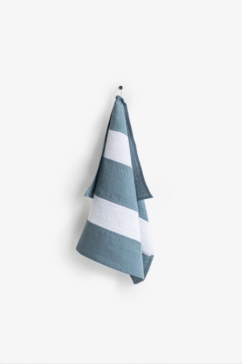 Striped Linen Tea Towel hanging on a hook, showcasing its durable, soft texture and eco-friendly design, ideal for stylish kitchen use.